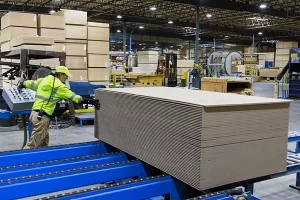 Image of man stacking primed paneling